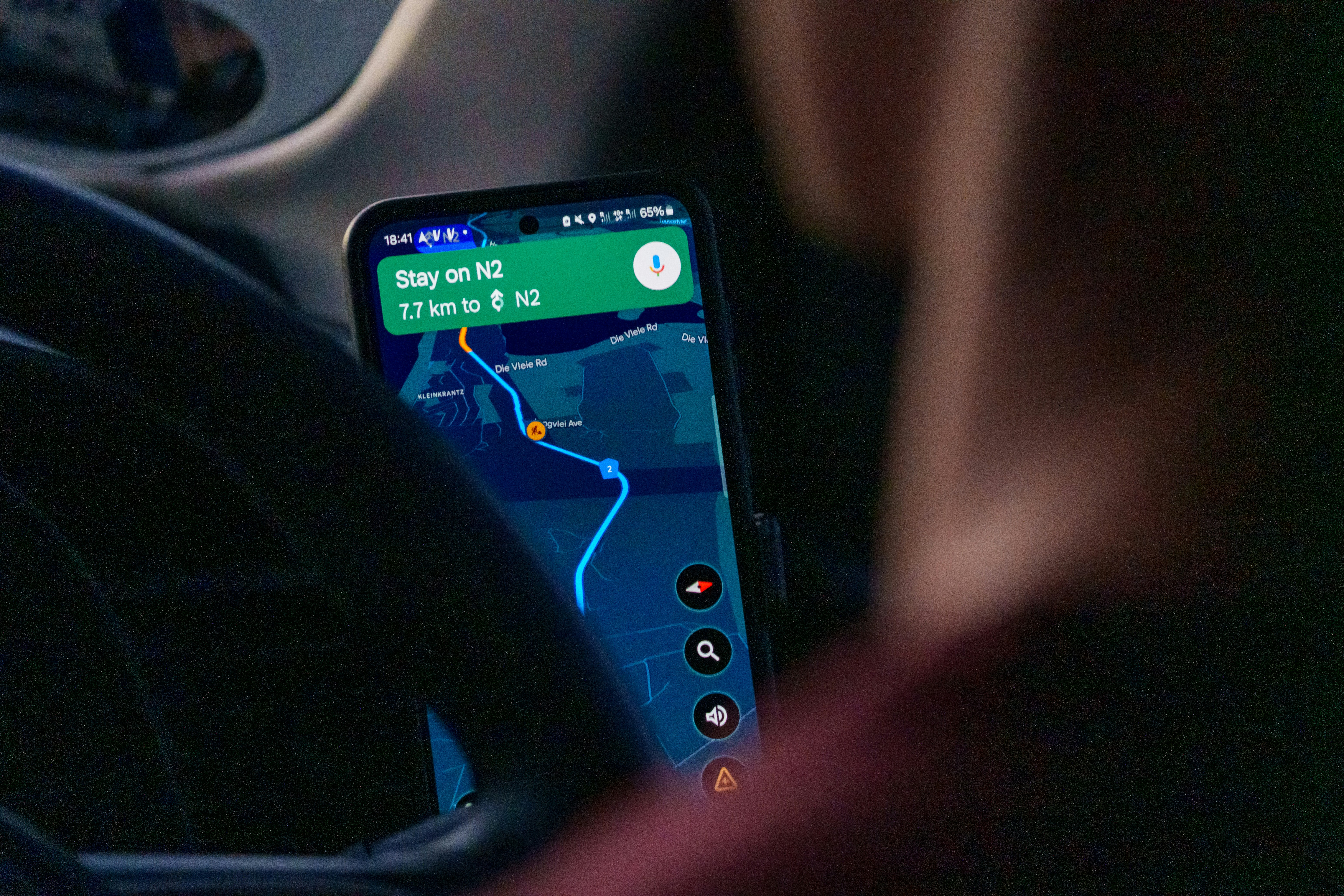 A man drives while using Google maps.
